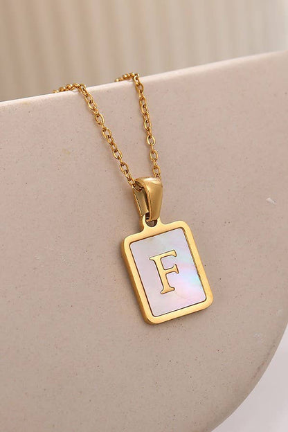 JOSSLYN by Wall to Wall stainless steel initial tarnish-free necklace, close-up view of sleek, minimalist jewelry accessory.