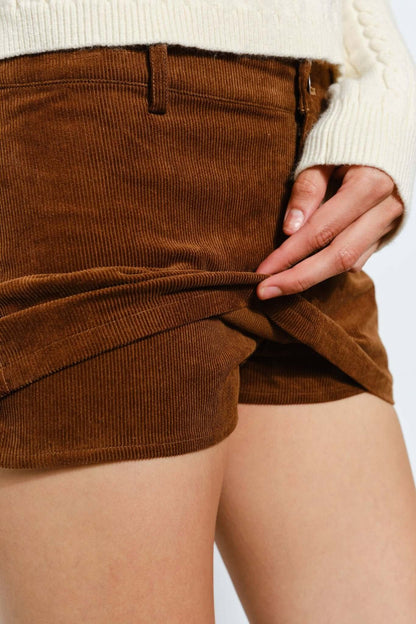 Light brown Peyton corduroy skort by Pretty Garbage featuring a casual, retro style with a fitted waistband and front pockets.