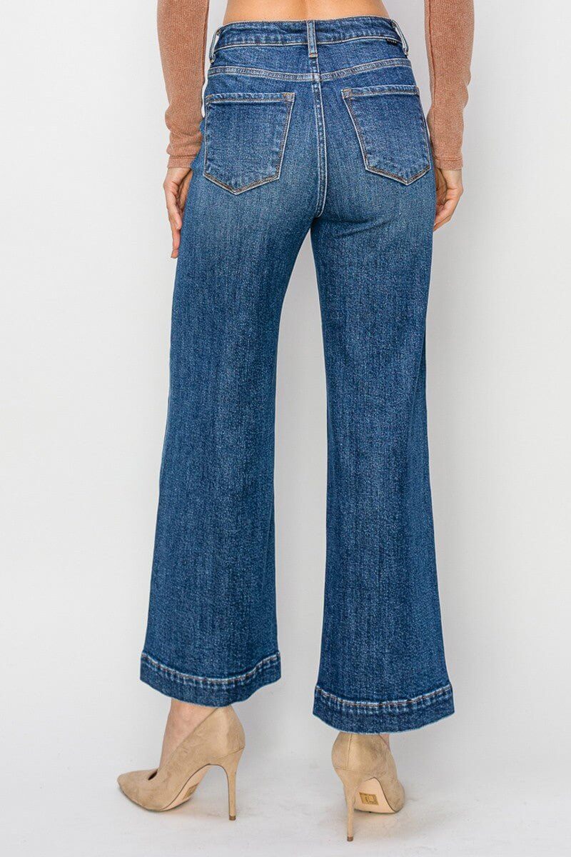 Risen high-rise ankle wide jeans displayed on a model, showcasing their stylish fit and denim texture.