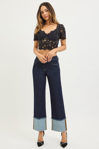 Risen mid-rise crop wide-leg cuffed jeans, stylish denim bottoms with a relaxed fit and rolled-up cuffs.