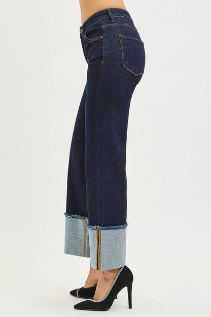 Risen Mid Rise Crop Wide Cuffed Jeans featuring a relaxed fit, light wash denim, and wide-leg design with rolled cuffs.