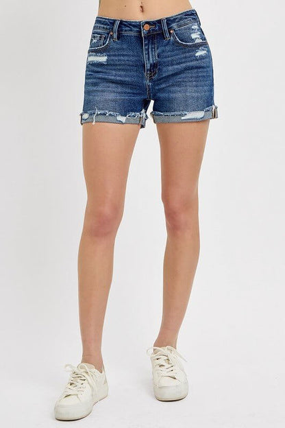 Risen women's mid-rise distressed cuffed denim shorts with rolled hems, showcasing a casual, stylish fit.