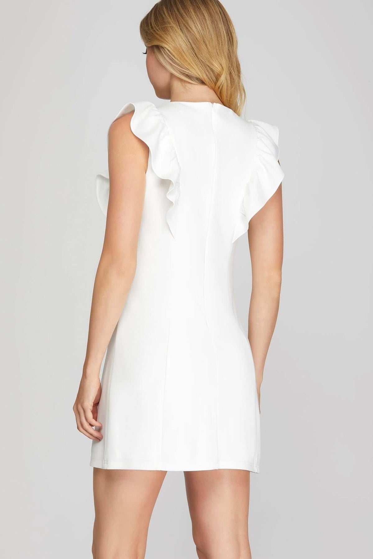She and Sky ruffle sleeve heavy knit mini dress showing a sleek, feminine design with bold ruffle accents and a fitted silhouette.