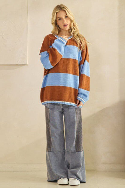 Rust and sky blue oversized striped knit sweater by Sage + Fig, featuring a cozy, chunky knit design and relaxed fit.