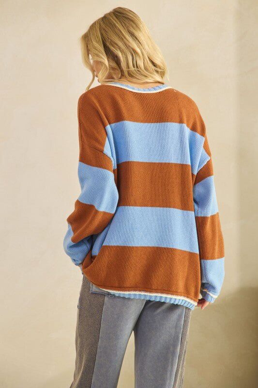 Rust and sky blue oversized striped knit sweater by Sage + Fig, featuring a cozy, chunky design and relaxed fit.