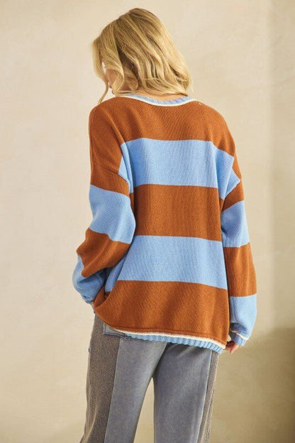 Rust and sky blue oversized striped knit sweater by Sage + Fig, featuring a cozy, chunky design and relaxed fit.