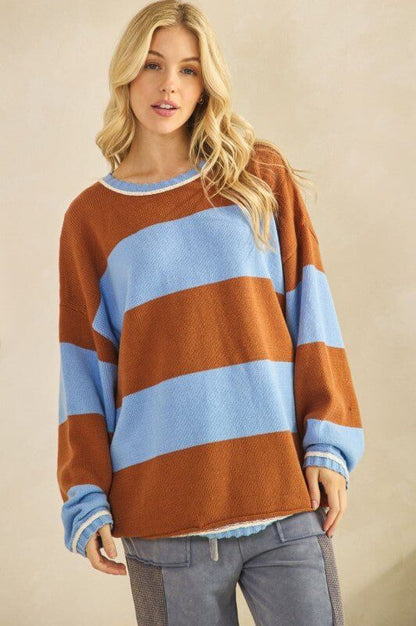 Rust and sky blue oversized striped knit sweater by Sage + Fig, featuring a cozy, chunky design with bold stripe patterns.