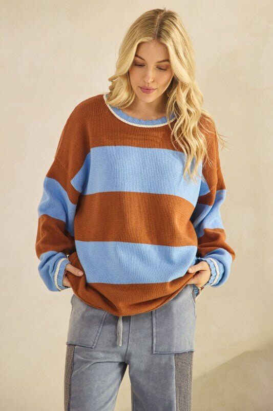 Rust and sky blue oversized striped knit sweater by Sage + Fig, featuring a cozy, relaxed fit and bold horizontal stripes.