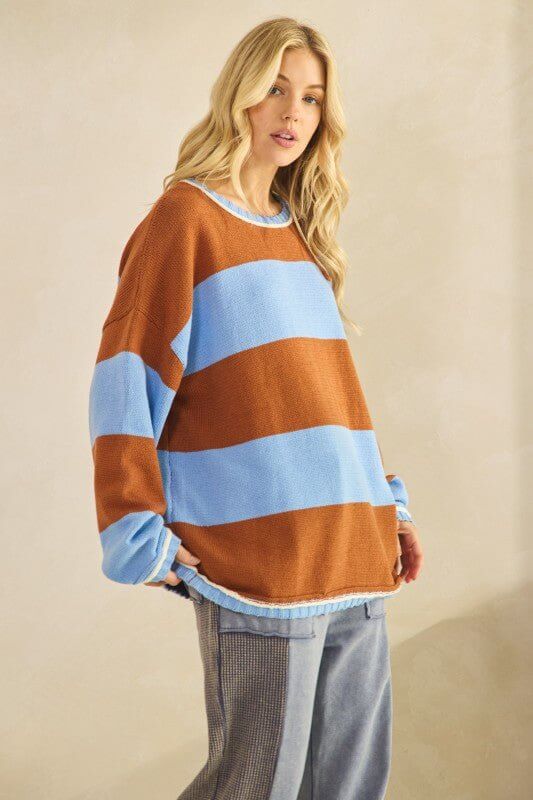 Rust and sky blue oversized striped knit sweater by Sage + Fig, featuring a cozy, relaxed fit with bold stripe pattern.
