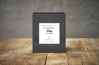 Miller Candle Co. Saddle Shop Candle with rustic saddle and leather accents, ideal for home decor and gift giving.