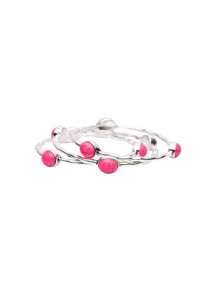 Set of three burnished silver bangles with pink oval stones from West & Co. jewelry accessories.