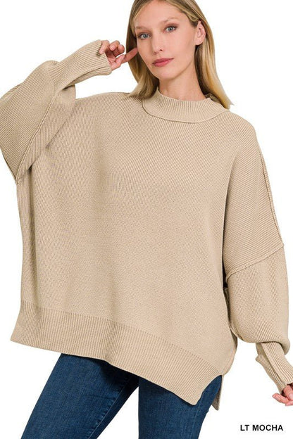 Zenana side slit oversized sweater featuring a relaxed fit and cozy knit fabric, shown from the side view.