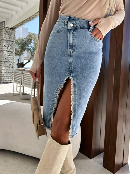 Hope & Sunshine solid color denim split skirt hanging on a rack with a casual, stylish look.