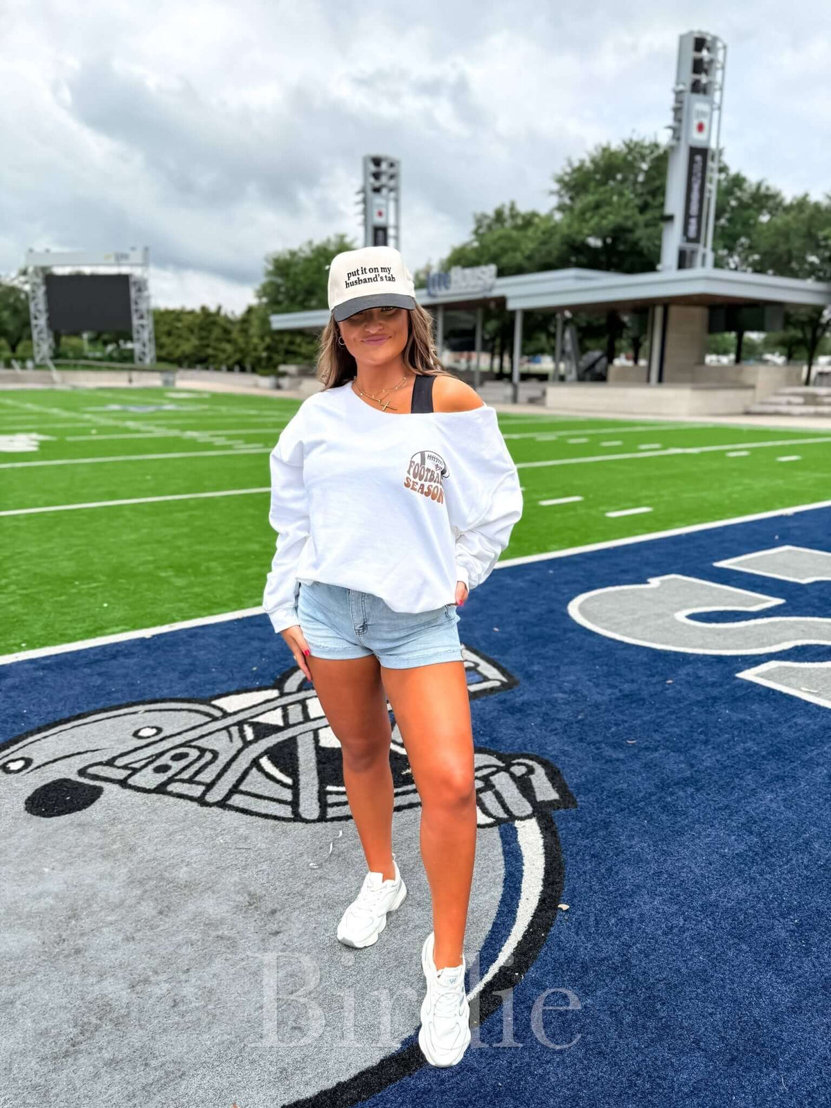 White graphic off-shoulder crew sweatshirt by birdie with "Sorry Can't Football Season" print on the front.