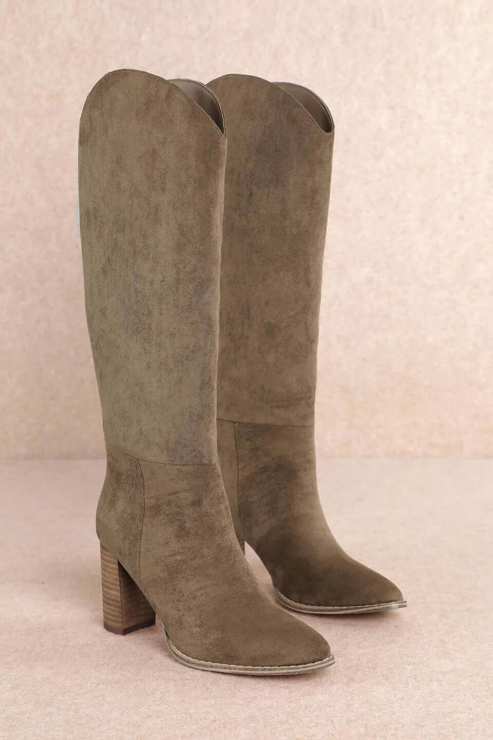 Taupe suede tall Western block heel boots by MI.MI, featuring a stylish design and pointed toe, perfect for Western-inspired outfits.