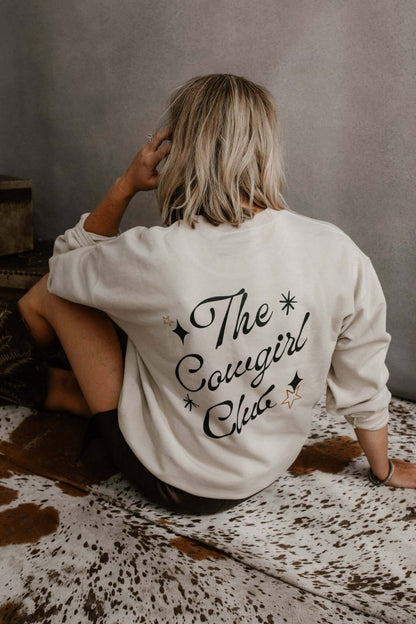 Pink graphic crewneck sweatshirt from Summer Tees' The Cowgirl Club collection, featuring cowgirl-themed design and comfortable fit.