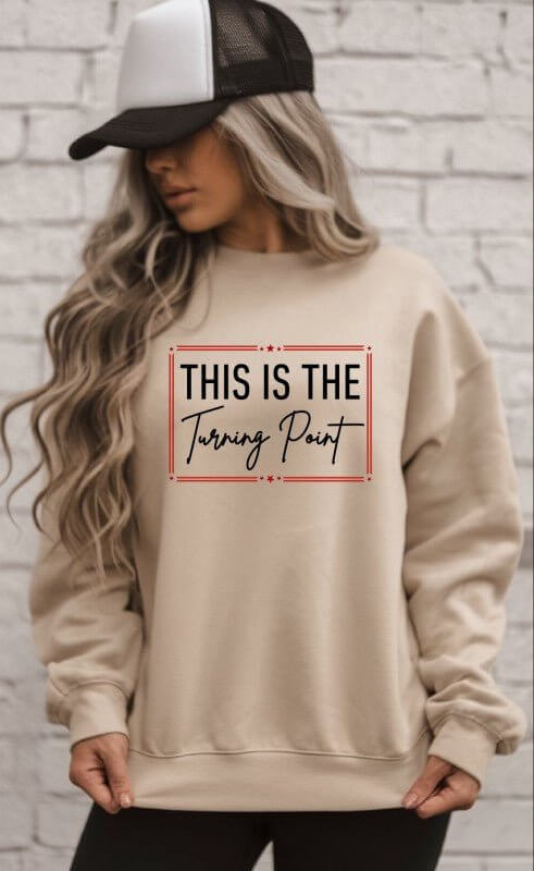 Ocean and 7th "This Is The Turning Point" graphic sweatshirt with bold design and comfortable fit, shown on a model.