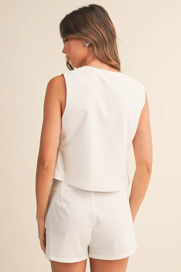 Klesis linen front tie sleeveless top and wrap skort set, stylish summer outfit with neutral tones and lightweight fabric.