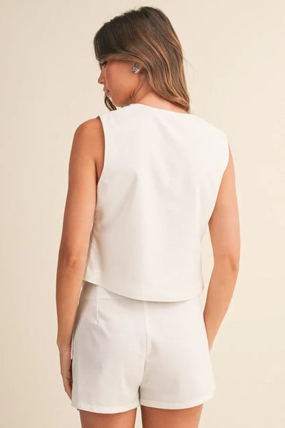Klesis linen front tie sleeveless top and wrap skort set, stylish summer outfit with neutral tones and lightweight fabric.