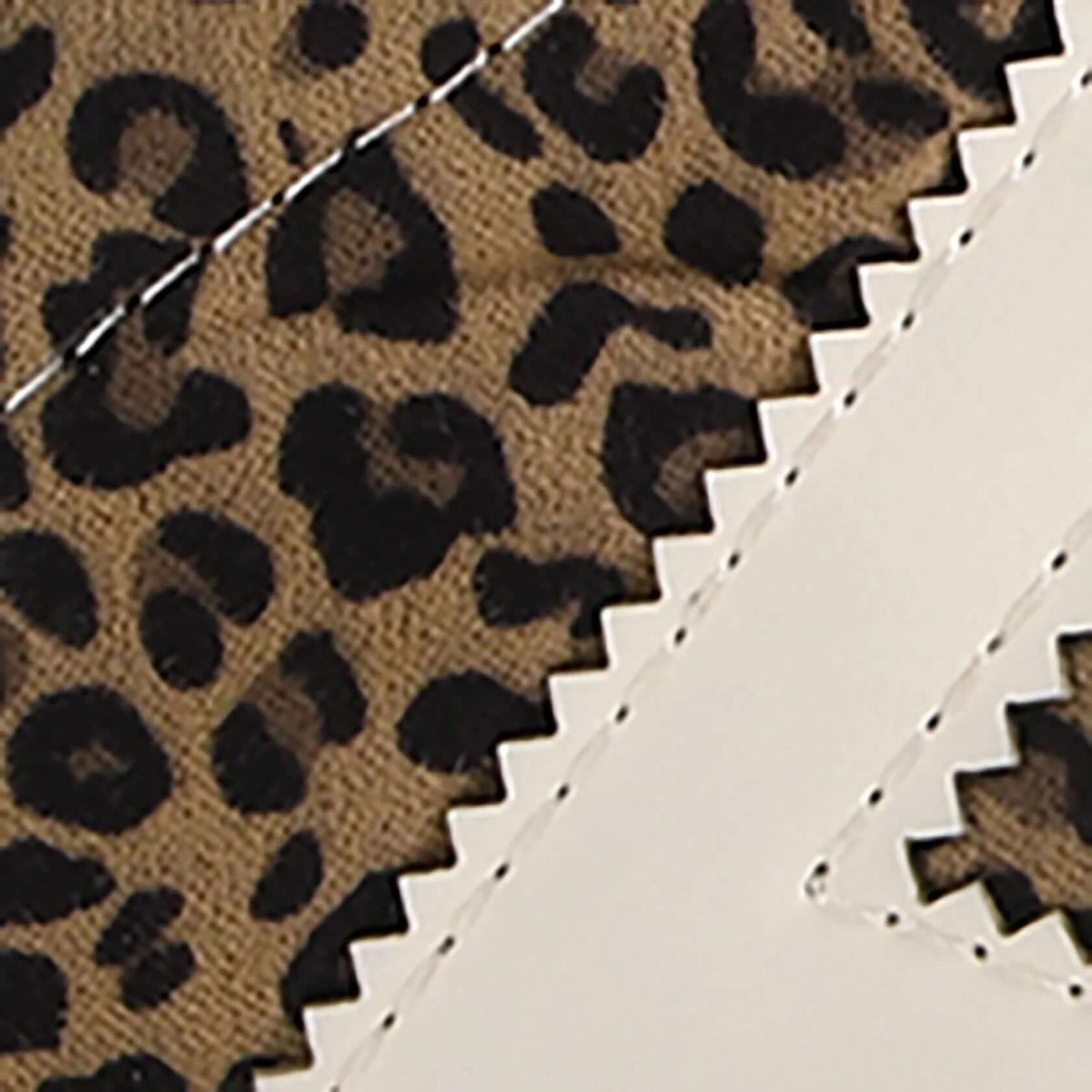 Dirty Laundry Trackstar Leopard sneaker showing a stylish leopard print design with white laces and a sporty silhouette.