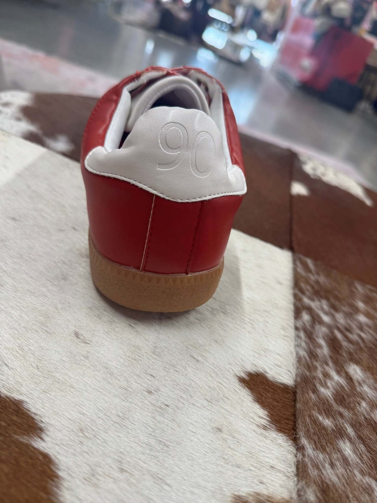 Red and white Dirty Laundry Trackstar Sneaker with stylish design and rubber sole, perfect for casual wear.