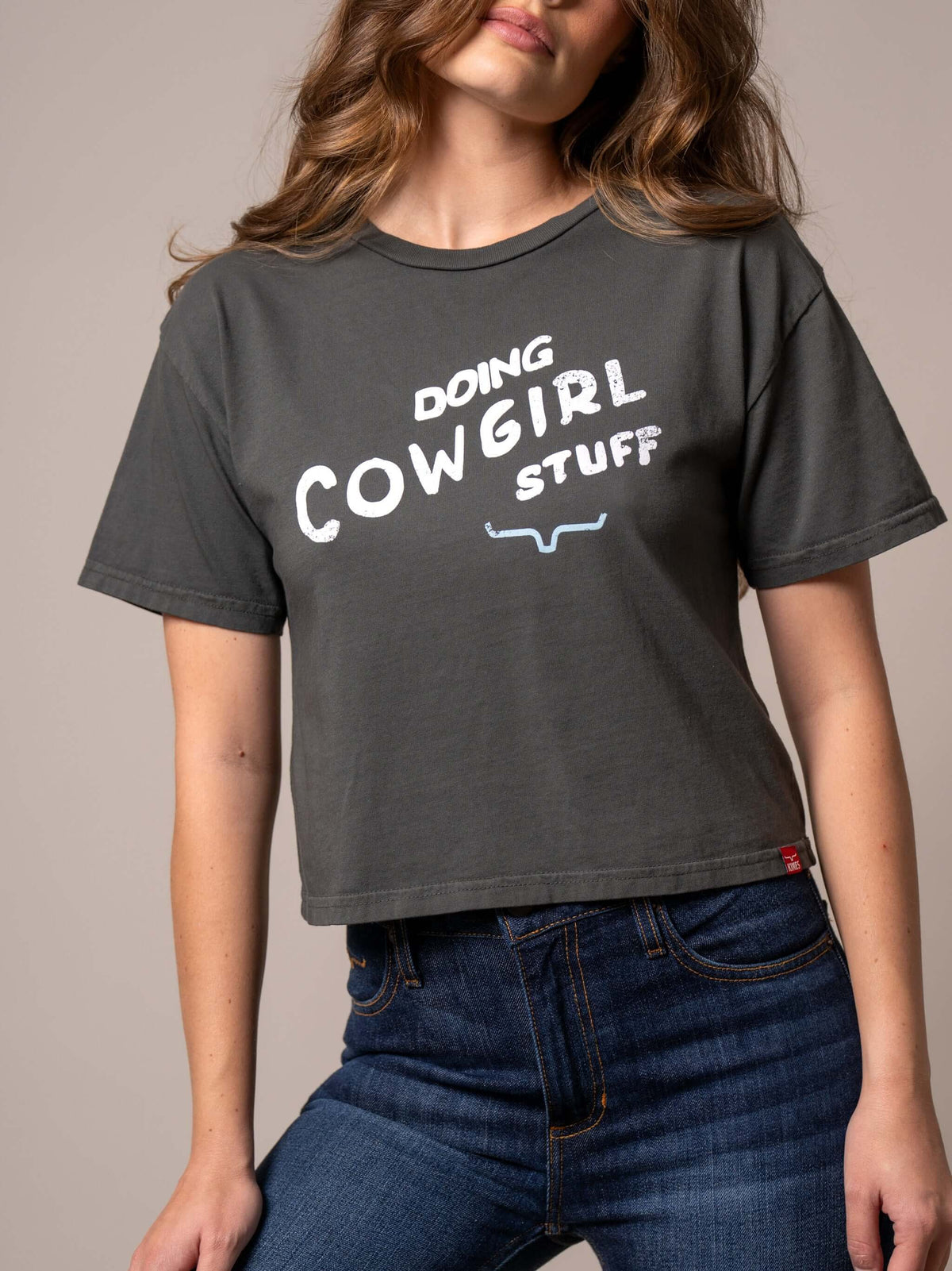 Kimes Ranch Doing Cowgirl Stuff cropped graphic tee with western-inspired design and casual fit, featuring bold cowgirl graphic.
