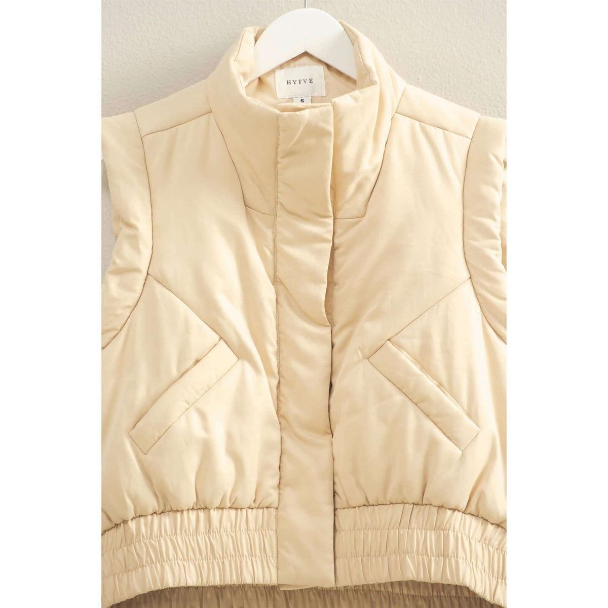 HYFVE versatile puffer vest in black, sleeveless outerwear with quilted design and stand collar, lightweight and warm.