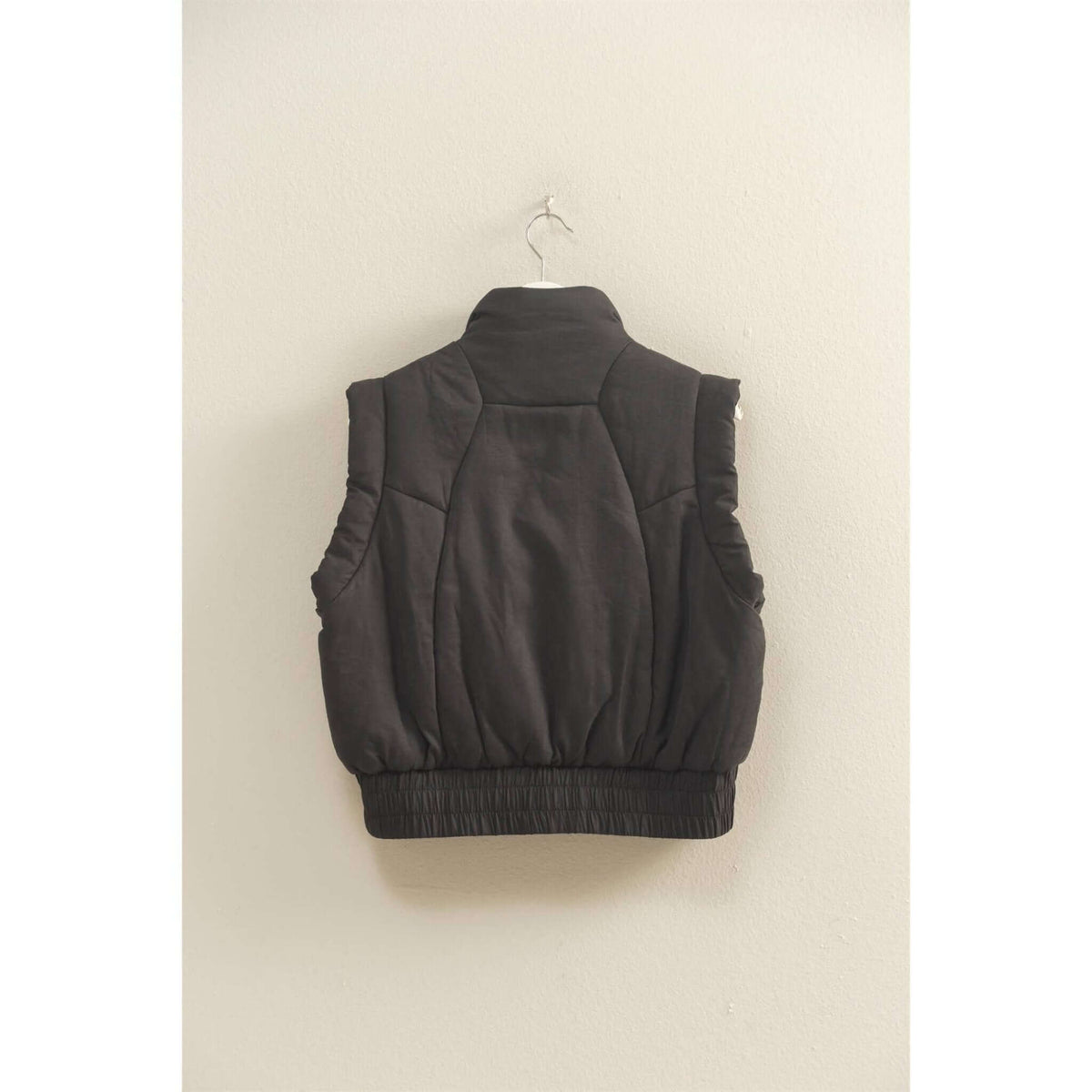 HYFVE versatile puffer vest in black, lightweight outerwear with a stand collar and zip closure, shown laid flat.