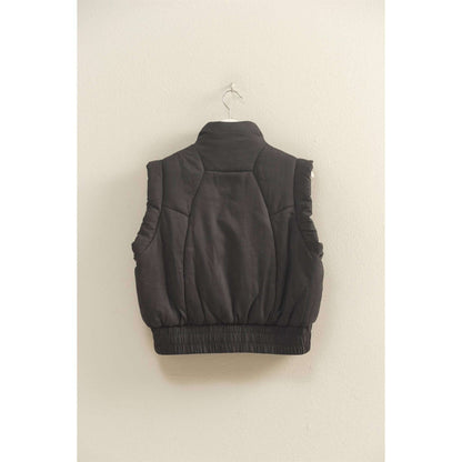 HYFVE versatile puffer vest in black, lightweight outerwear with a stand collar and zip closure, shown laid flat.