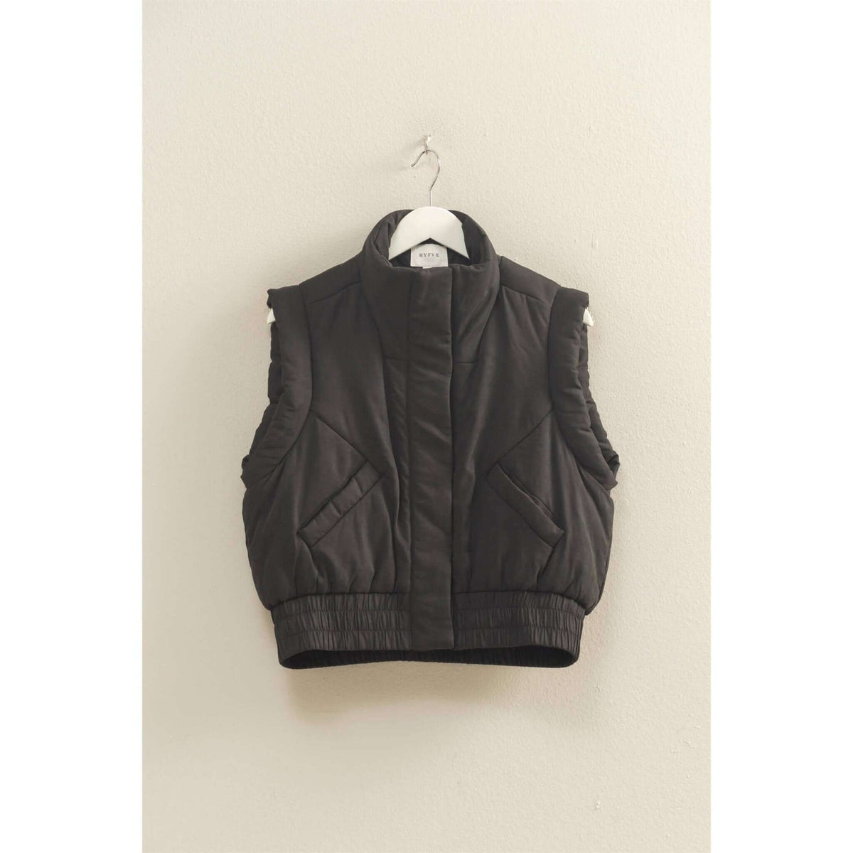 HYFVE versatile puffer vest in black, lightweight outerwear with a quilted design and zip closure, ideal for layering.