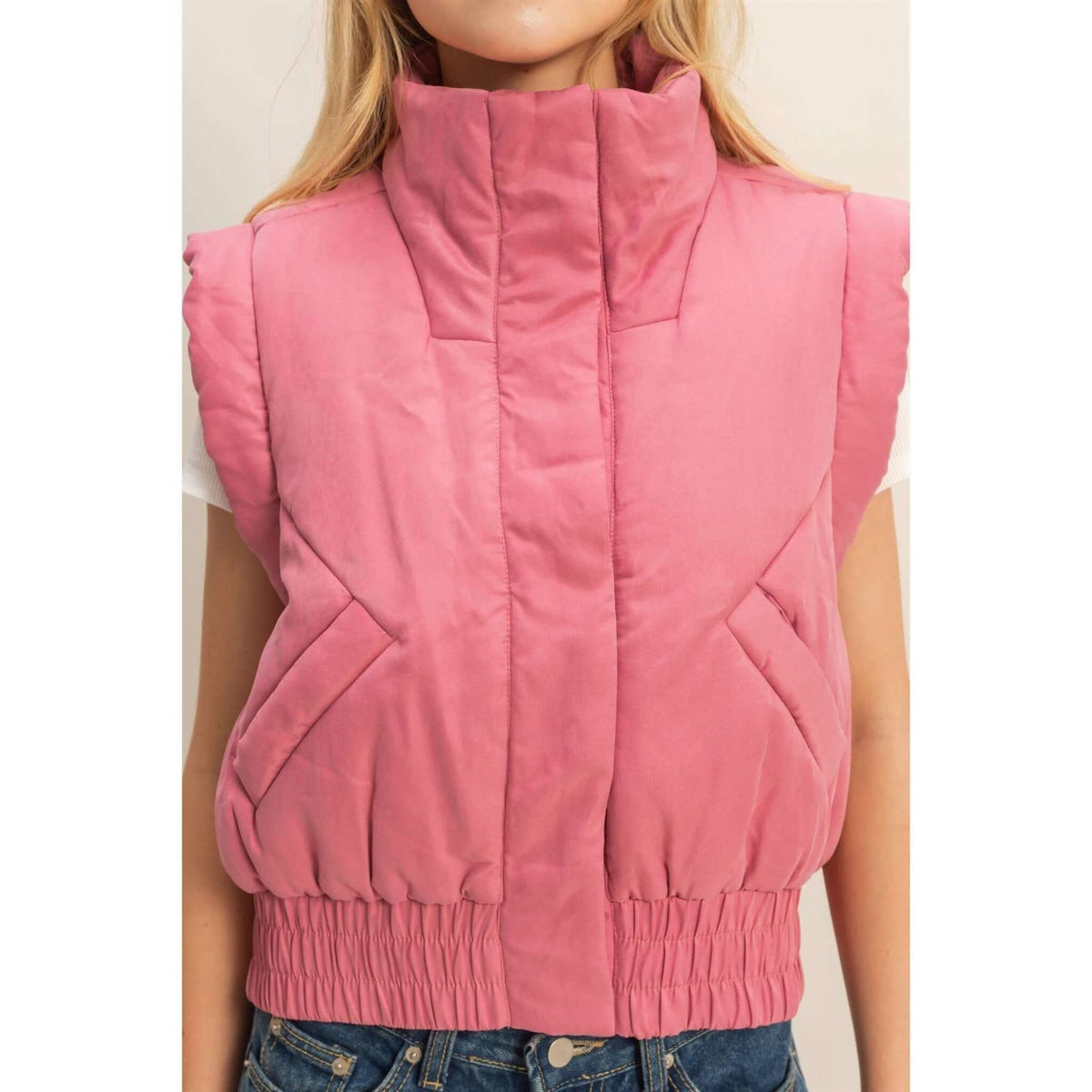 HYFVE versatile puffer vest in a neutral color, showcasing its lightweight, quilted design and front zip closure.