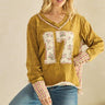 Vintage mustard floral number 17 patchwork short sleeve sweater by Sage + Fig, featuring colorful floral and patchwork design.