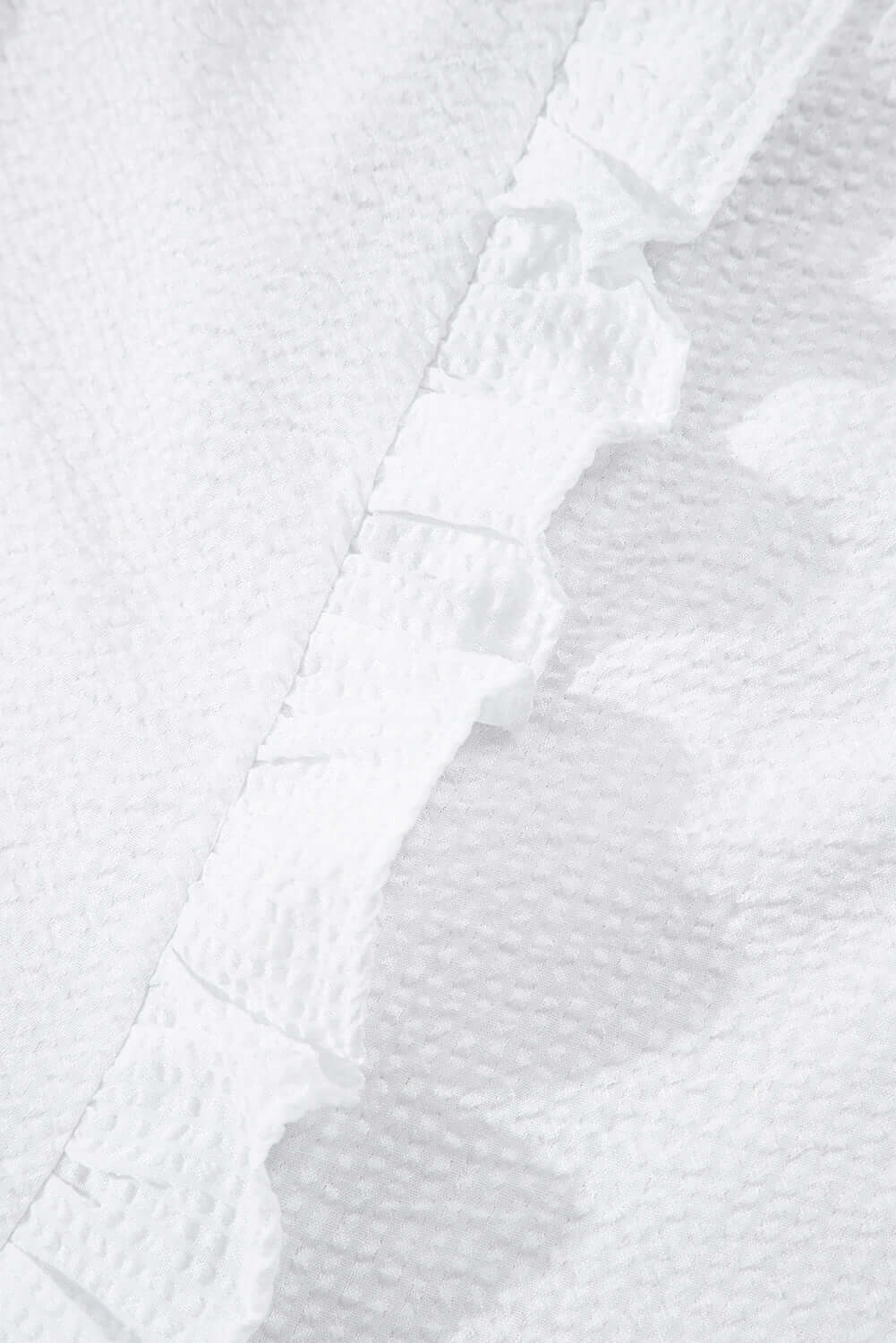 White ruffle front puff sleeve blouse by Cowgirl Charm, featuring feminine ruffles and voluminous puff sleeves.