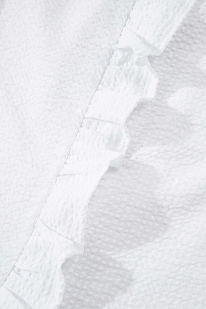 White ruffle front puff sleeve blouse by Cowgirl Charm, featuring feminine ruffles and voluminous puff sleeves.