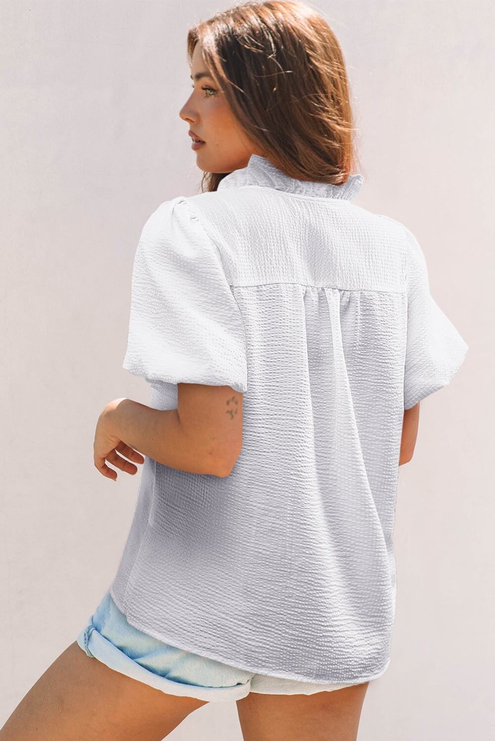 White ruffle front puff sleeve blouse by Cowgirl Charm, featuring feminine ruffles and voluminous puff sleeves.