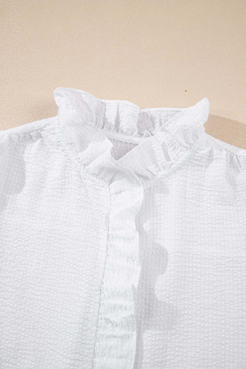 White ruffle front puff sleeve blouse by Cowgirl Charm, featuring feminine ruffles and puffed sleeves, perfect for casual or dressy wear.