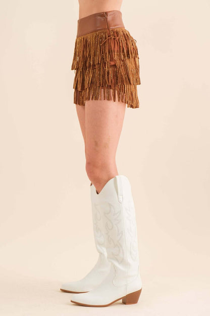 Blue B wide faux leather waist shorts with tiered fringe and studded details, featuring a stylish and edgy design.