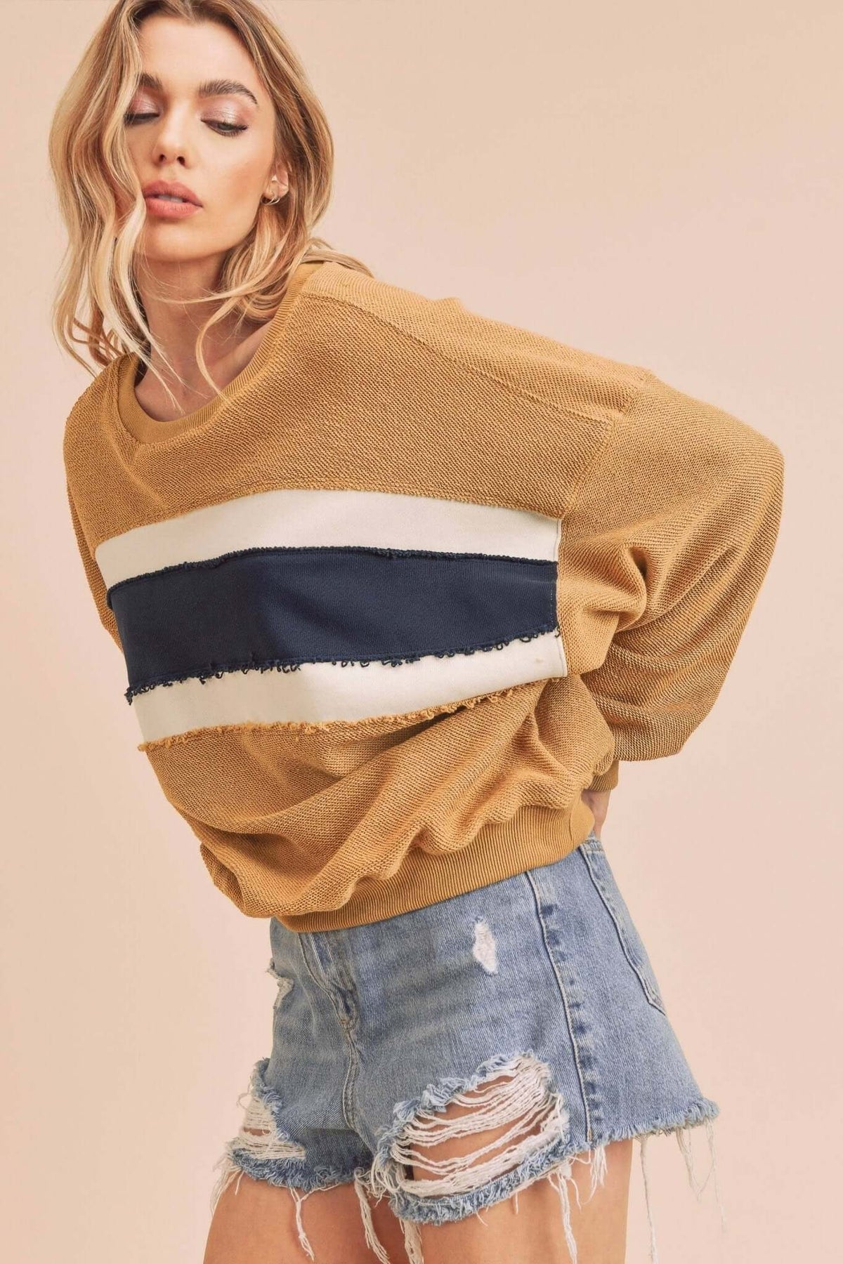 AEMI + CO Winnie sweatshirt featuring a colorful Winnie the Pooh graphic on soft, cozy fabric for casual wear.