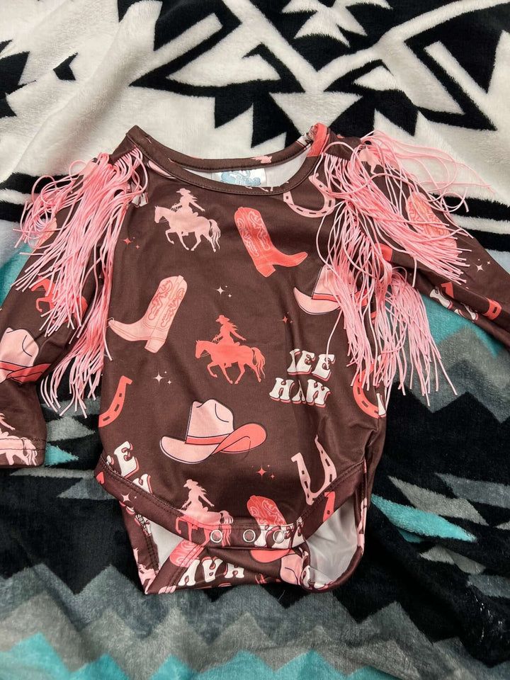 Pink Shea Baby Yeehaw Fringe Onesie for kids with fringed design, soft fabric, and playful Western-inspired style.