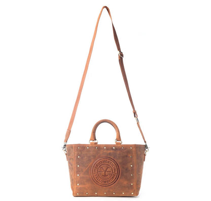 Yellowstone Legancy studded leather tote bag by Cowgirl Charm featuring a rugged design and silver stud accents.