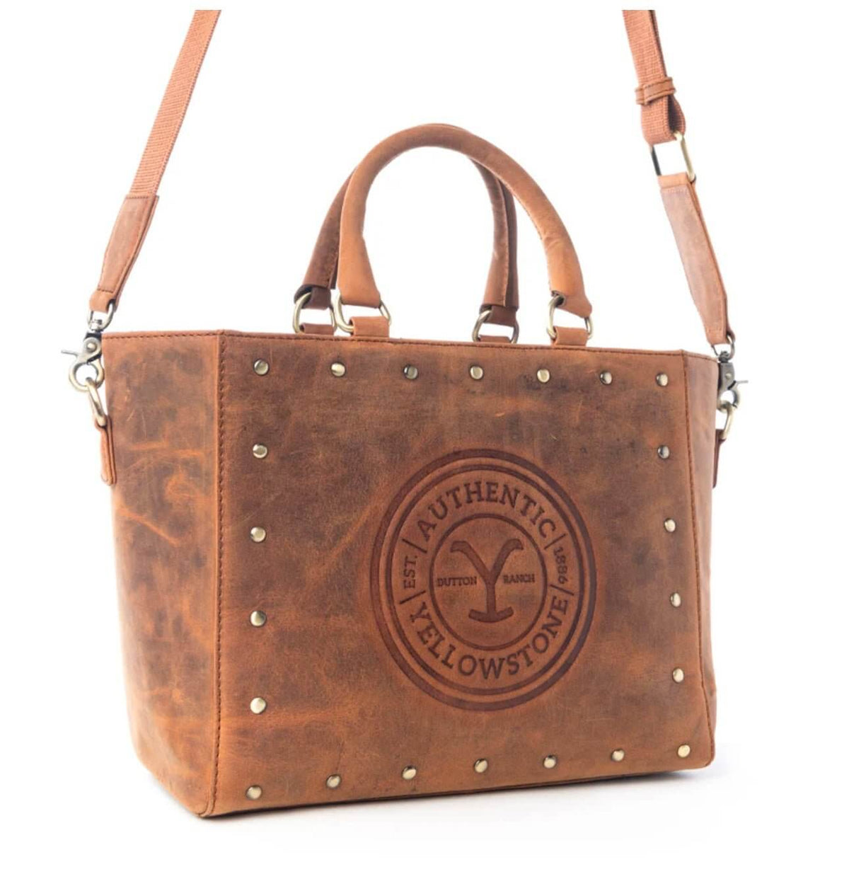 Yellowstone Legancy studded leather tote bag by Cowgirl Charm, featuring a spacious design with metal stud accents and sturdy handles.