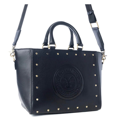 Yellowstone Legancy studded leather tote bag by Cowgirl Charm, featuring a spacious design with metal stud accents and sturdy handles.